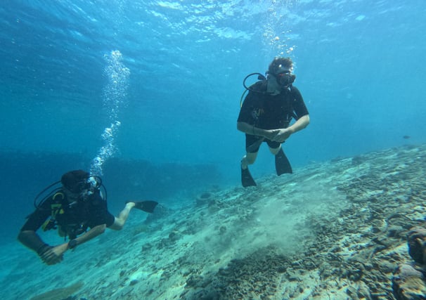 cuba diver exploring the coral-covered USAT Liberty wreck in Tulamben, Bali during early morning dive