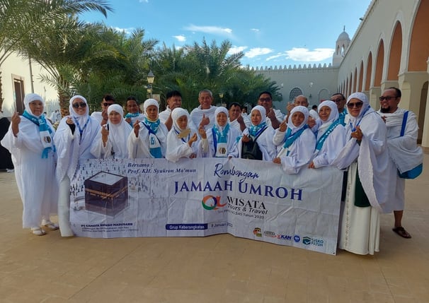 a group of people standing around a banner