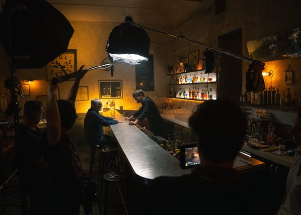 Film crew filming TV shot for a whisky in a Prague bar