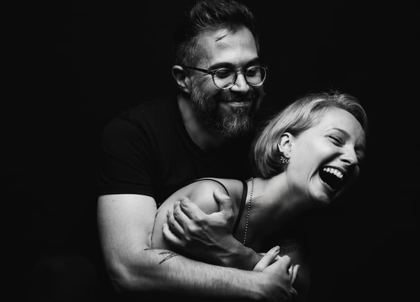 two people in embrace laughing and in love 