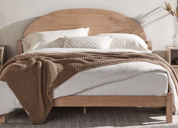 neutral tan bed frame, brown throw blanket, white comforter, neutral paint