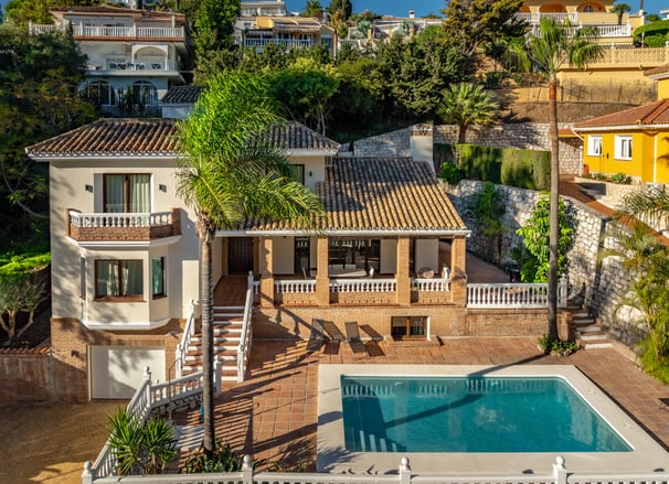 a house with a pool and a pool in the foreground
