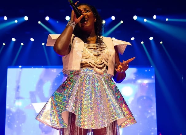 a woman in a white dress and a microphone