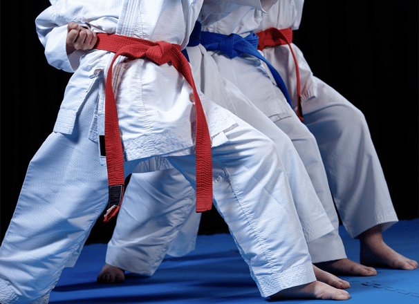 a group of people standing on a blue mat