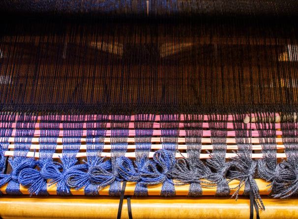 The start of a weaving project tied up on a loom.