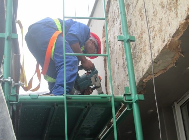 Mechanical stripping of compromised exterior plaster for waterproofing works, Sandhurst Towers, Sandton