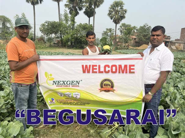 a group of men standing in a field with a banner that says welcome to the