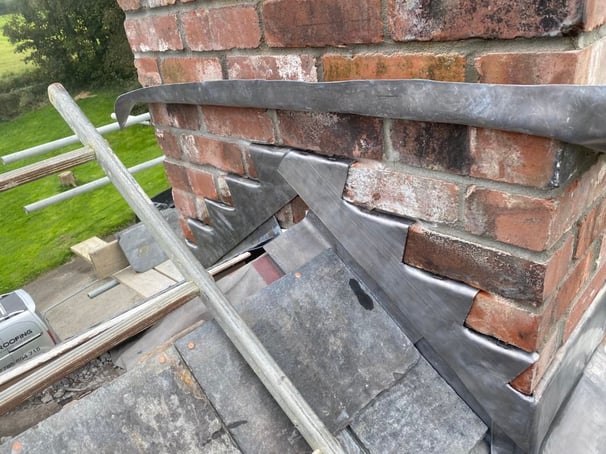 Repairs at Blable house near Wadebridge, Cornwall. Renewal of lead flashing around the chimney.