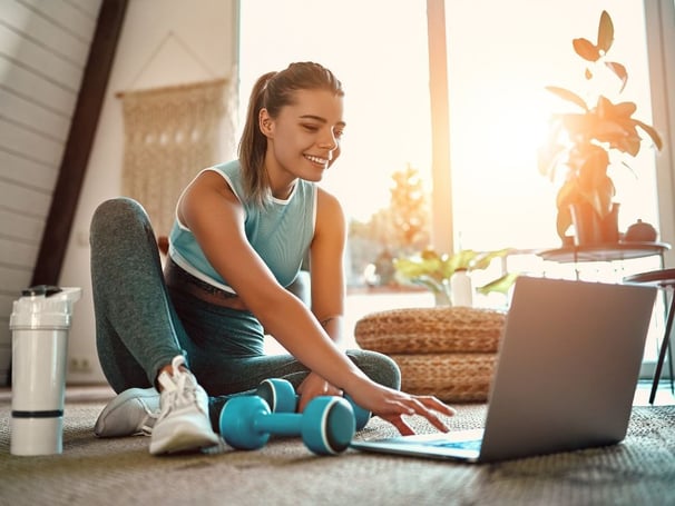 a woman sitting having a virtual physio session with the london physio