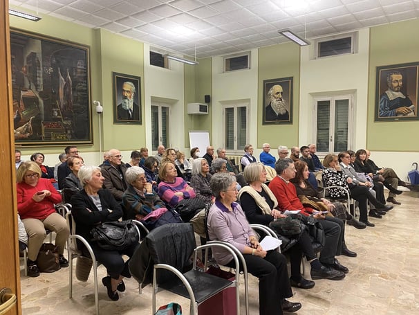 a group of people sitting in chairs in a room