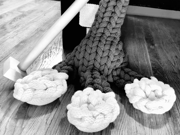 Closeup of FROG's foot, knit toes, knitting needles by Dundee & Lee's Emilie Odeile & Ken Chapin.