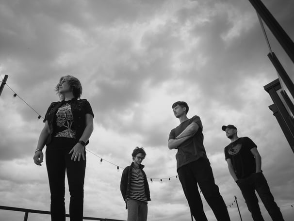 a group of people standing on a skateboard