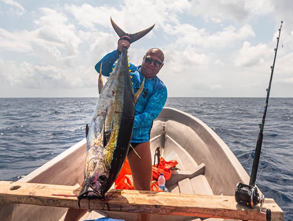 Zanzibar Fishing Trips – happy angler proudly displaying a caught Yellowfin Tuna in Zanzibar