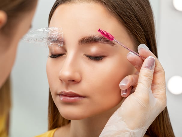 Esthetician performing eyebrow lamination