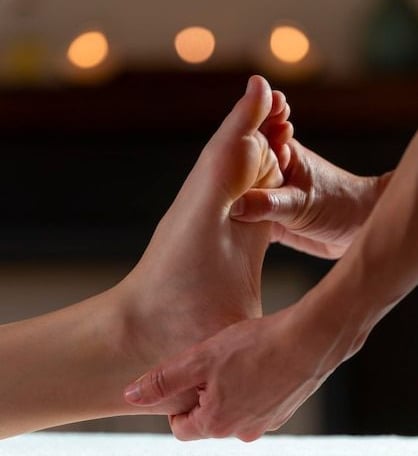 a person's foot and foot in a massage room