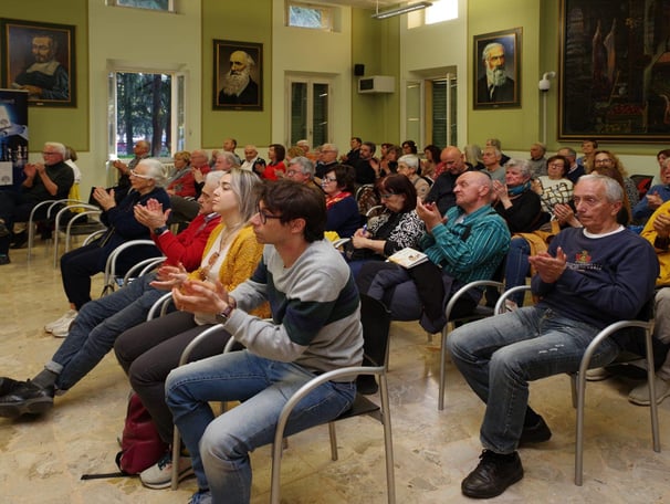 a group of people sitting in chairs in a room