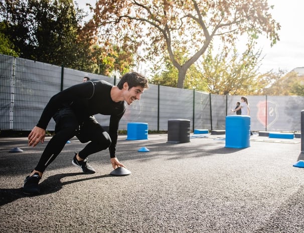 a man over 40 in a black compression tights exercising outdoors