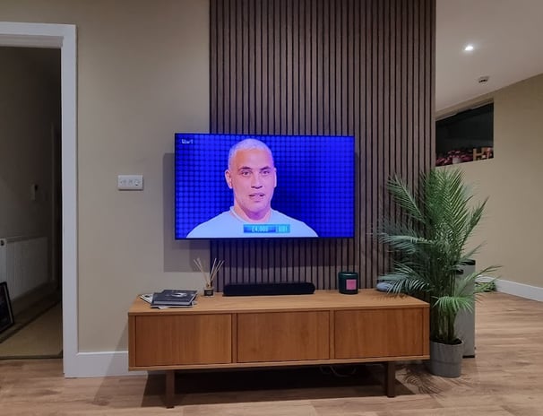 a bespoke feature wall with television and AV cabinet