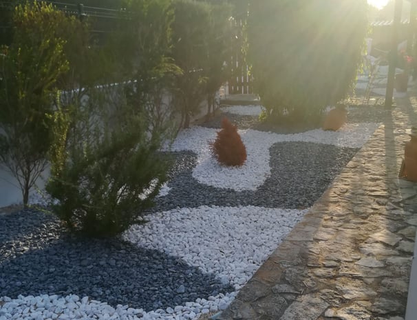 a garden with a gravel path and gravel path