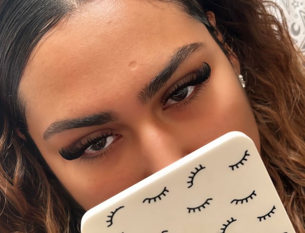 alt="mobile lash technician applying lashes in London home"