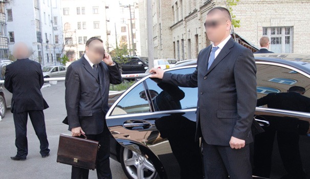 VIP escorted by security guards to an armored vehicle for discreet and secure transportation