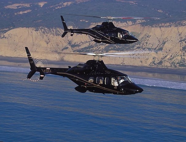 Two AW109 helicopters in flight, showcasing precision engineering and operational reliability.