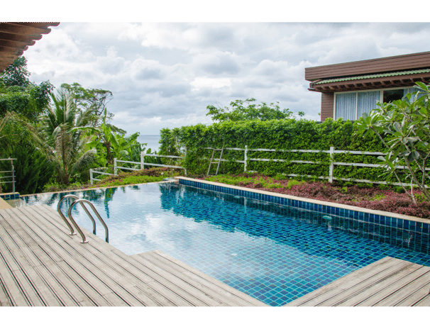 Beautiful setting with wood-planked deck surrounding a zero-edge square pool