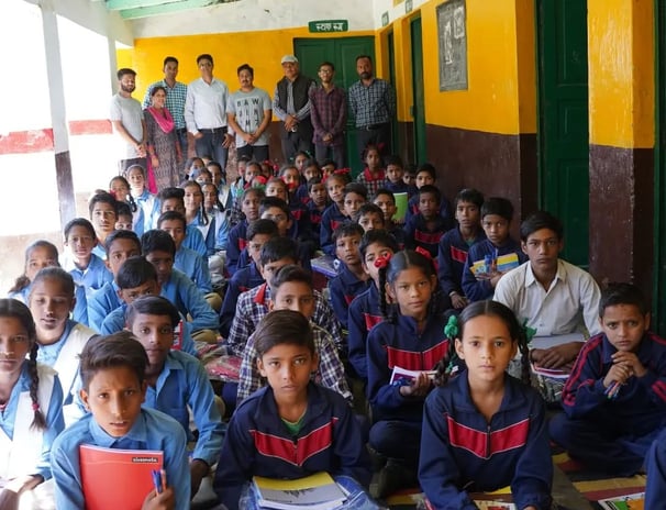 Children sitting with stationary