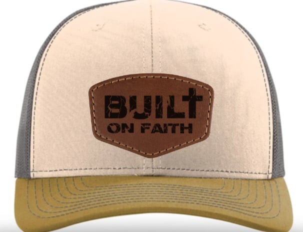 a brown and tan colored hat with a built on faith on it