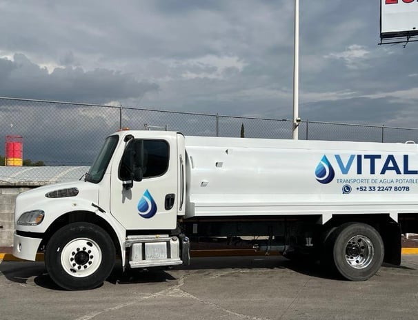 a white truck with a large water tank on it