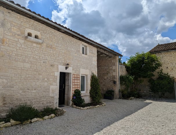 a stone building with a door and a door way to the outside