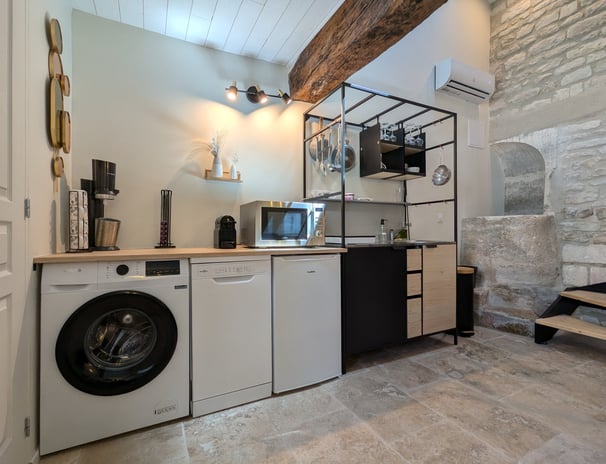 a kitchen with a washing machine and a washing machine