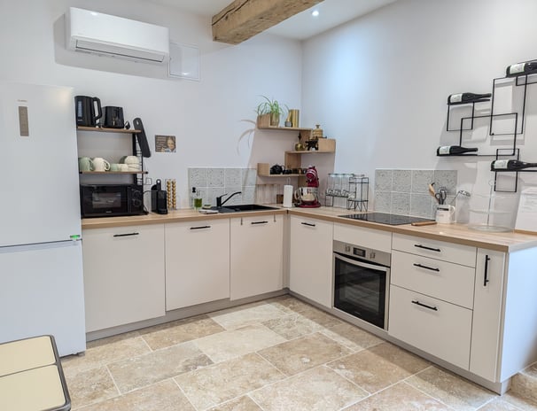 a kitchen with a refrigerator, microwave, and oven