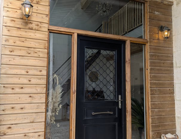 a black door with a black door and a potted planter