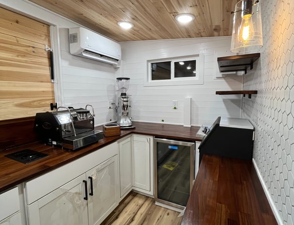 espresso and grinder setup inside custom mobile coffee trailer