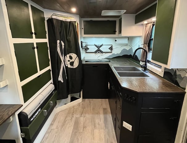 kitchen layout inside and expedition rig featuring fridge, freezer, sink, induction cooktop