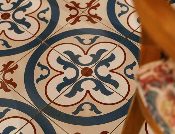 this image has hand painted tile in patio