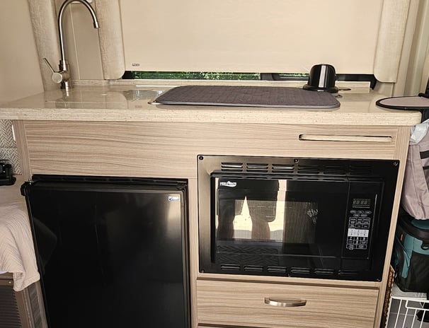 Kitchen of barely used 2023 Entegra Coach Ethos 20T Class B RV for sale.