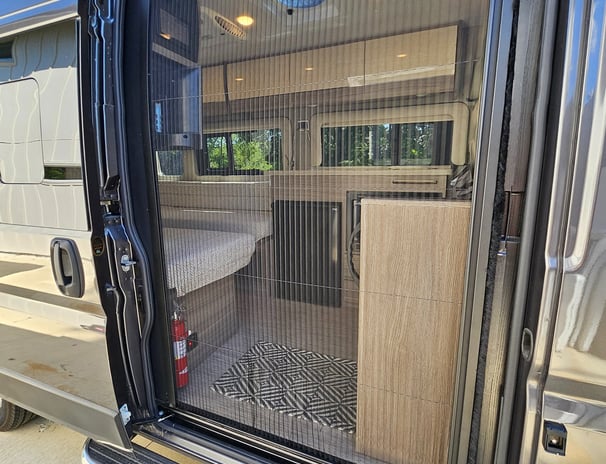 Screen door on used 2023 Entegra Coach Ethos 20T Class B RV for sale.