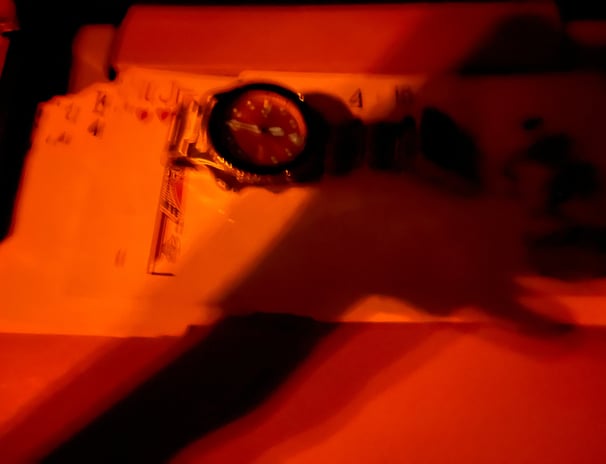 a person holding a clock and a clock on a table