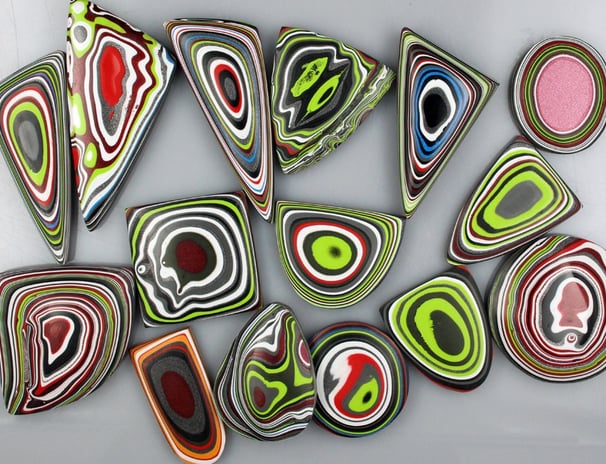 "Multicolored Fordite cabochons with swirling layers from vintage automotive paint"