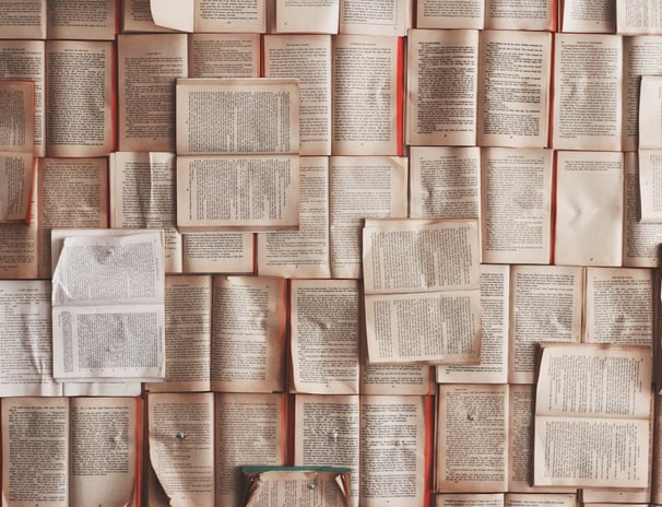 a wall of books and a bottle of wine