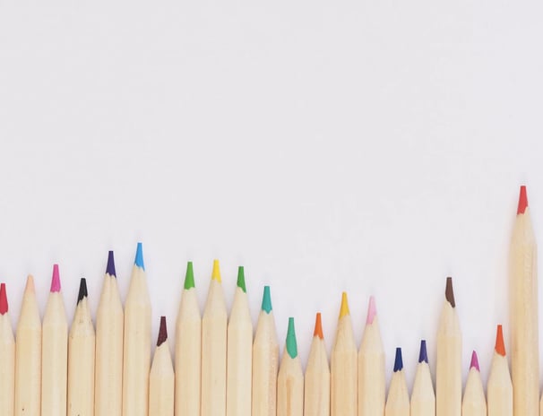 a group of colored pencils and colored pencils