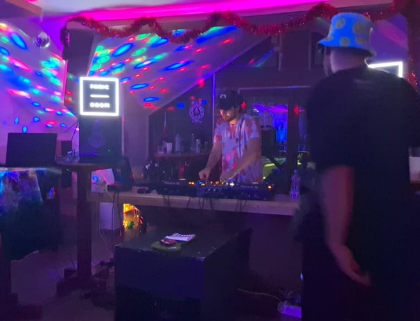 a man becing the DJ pult, mixing music
