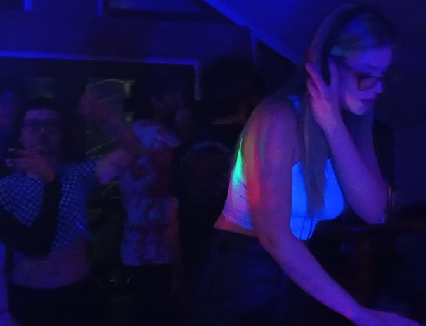 a woman in a white shirt mixing music