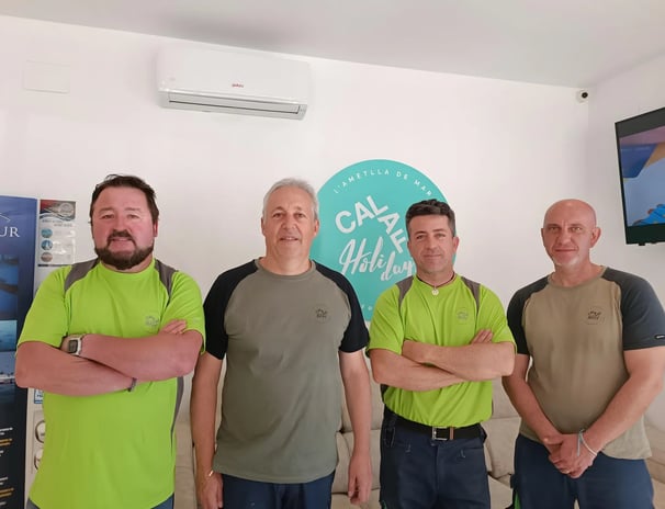 a group of men standing in front of a television
