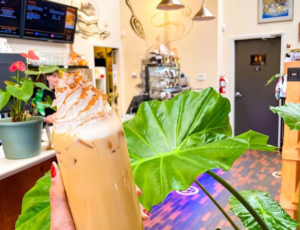 a person holding a drink in a restaurant