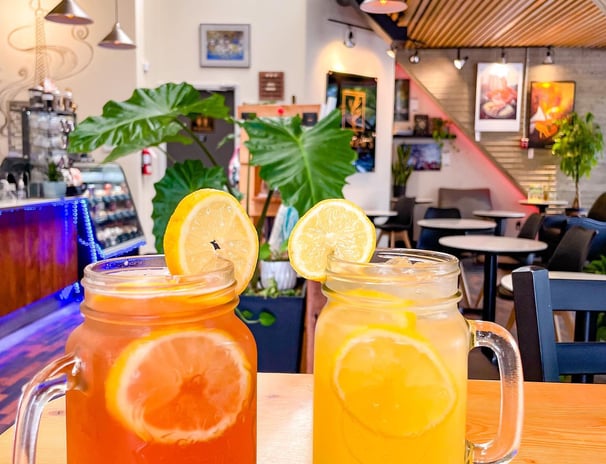 two mason jars filled with ice tea lemonade