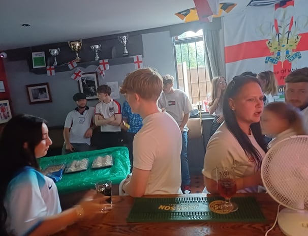 a group of people standing around a bar