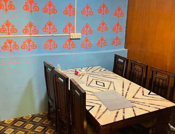 a table with a tablecloth and chairs in Sarpanch Restaurant Bareilly Fatehganj